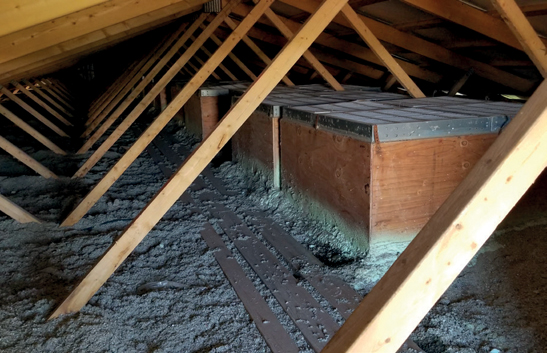 Attic housing built over a ceiling inlet in a barn attic